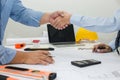 Architect and businessman shaking hands meeting discuss a plan about the construction project of real estate. Agreement and are Royalty Free Stock Photo