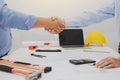 Architect and businessman shaking hands meeting discuss a plan about the construction project of real estate. Agreement and are Royalty Free Stock Photo