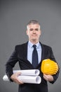 Architect carrying blueprints and hardhat Royalty Free Stock Photo
