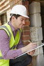 Architect Checking Insulation During Construction Project Royalty Free Stock Photo