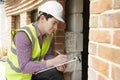 Architect Checking Insulation During House Construction Royalty Free Stock Photo