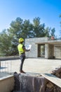 Architect checking the plans of a house under construction