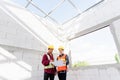 Architect and client discussing the plan with blueprint of the building at construction site Royalty Free Stock Photo