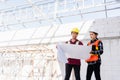 Architect and client discussing the plan with blueprint of the building at construction site Royalty Free Stock Photo