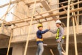 Architect and construction engineer holding hands while working for teamwork and cooperation concept after completing