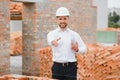 Architect at a construction site with blueprints Royalty Free Stock Photo