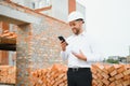 Architect at a construction site with blueprints Royalty Free Stock Photo