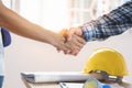 Architect contractor shaking hands with client after seal a deal to renovate building