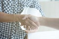 Architect and customer shaking hands at workplace. Engineer hand