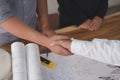 Architect & customer shaking hands. Engineer handshaking with pa