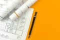 Architect design concept. Desktop with drawing sketch plans and blueprints. Orange background, copy space and top view Royalty Free Stock Photo