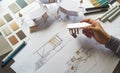 Architect design working drawing sketch plans blueprints and making architectural construction model in architect studio Royalty Free Stock Photo