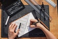 Architect and designer working accurately on a project drawing sketches and technical drafts on paper using professional tools Royalty Free Stock Photo