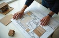 Architect, designer working on blueprint with house model, materials samples. Project plan concept, creative work on interior Royalty Free Stock Photo