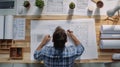Architect designing a modern building blueprint
