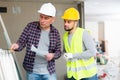 Architect discussing workflow with builder at construction site indoors Royalty Free Stock Photo