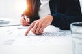 Young man designer sketching a construction project at notebook and drawing plan while working at office