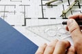 Architect drawing on blueprint