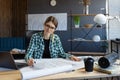 Architect drawing blueprints in office. Engineer sketching a construction project. Architectural plan. Close-up portrait Royalty Free Stock Photo