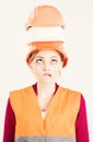 Architect, engineer, builder shocked about construction, real estate. Woman with confused grimace face in uniform, white Royalty Free Stock Photo