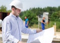 Architect or engineer checking plans on site Royalty Free Stock Photo