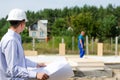 Architect or engineer checking plans on site Royalty Free Stock Photo