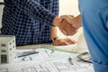 Architect and engineer construction workers shaking hands after successful collaboration Royalty Free Stock Photo