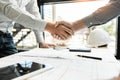 Architect and engineer construction workers shaking hands while working for teamwork and cooperation concept after finish an Royalty Free Stock Photo