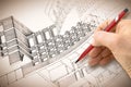 Architect or engineer designing a sketch of a new residential building in a new modern town Royalty Free Stock Photo