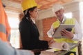 Architect Engineer And Manual Worker Meeting In Construction Site Royalty Free Stock Photo