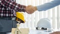 The architect and engineer shook hands while working as a team and cooperation concept after completing the agreement in the Royalty Free Stock Photo