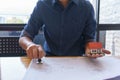 Architect or engineer stamping the document or blueprint on wooden desk - architectural project, Construction concept