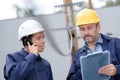 architect and engineer talking on construction site