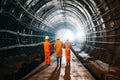 Architect and Engineer wearing safety underground construction supervisor checking the transport pipe tunnel boring machine for
