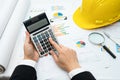 Architect or engineer working project accounting with graph with tools in office, Construction account. Royalty Free Stock Photo