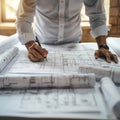 Architect finalizing plans at sunlit workstation Royalty Free Stock Photo