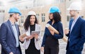 Architect group, people at construction site and inspection with tablet and blueprint, diversity and happy outdoor Royalty Free Stock Photo