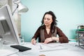 Architect at her working desk with blueprints in front Royalty Free Stock Photo