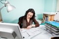 Architect at her working desk with blueprints in front Royalty Free Stock Photo