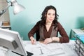 Architect at her working desk with blueprints in front Royalty Free Stock Photo