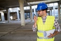 Architect holding rolled up blueprints at construction site Royalty Free Stock Photo