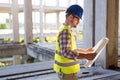 Architect holding rolled up blueprints at construction site Royalty Free Stock Photo