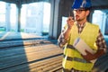 Architect holding rolled up blueprints at construction site Royalty Free Stock Photo