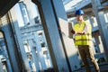 Architect holding rolled up blueprints at construction site Royalty Free Stock Photo