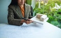 An architect holding and working on an architecture house model with shop drawing paper in the office Royalty Free Stock Photo