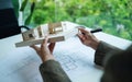 An architect holding and working on an architecture house model with shop drawing paper in the office Royalty Free Stock Photo