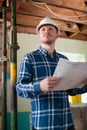 Architect Inside House Being Renovated Studying Plans