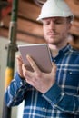 Architect Inside House Being Renovated Using Digital Tablet