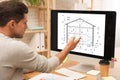 Architect making project of house on computer