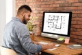 Architect making project of house house on computer